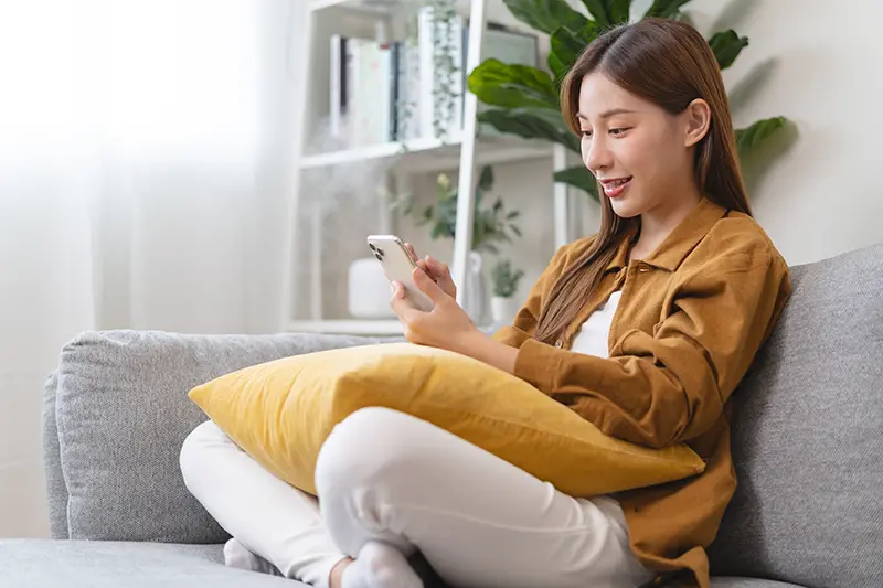 Young woman enjoying mind free moment relax and calm on the sofa at home