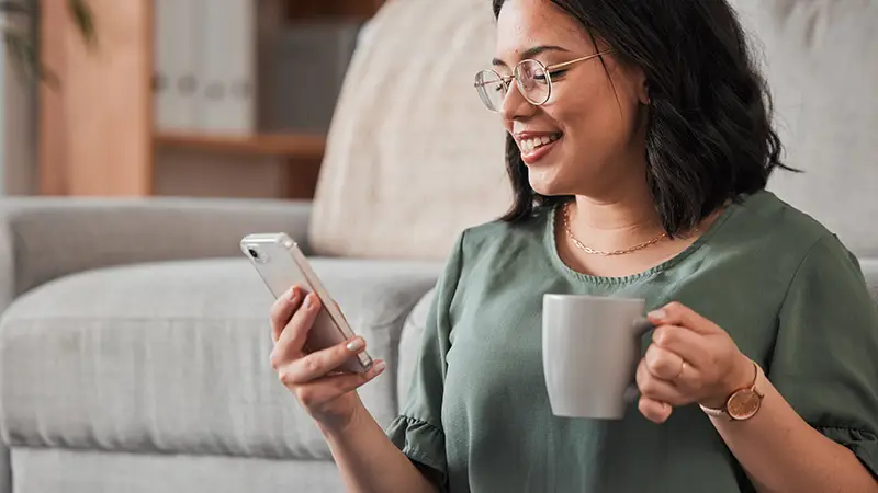 Woman using iCare+ app on phone to talk to an iCare+ provider for online weight loss program